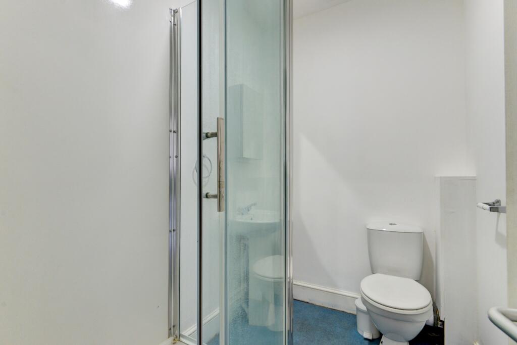 A clean and modern single toilet room featuring...