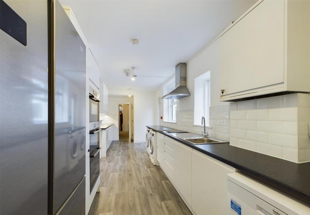 Bright and modern galley kitchen featuring slee...