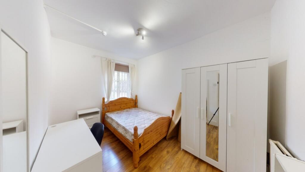 A bright and inviting double bedroom featuring ...