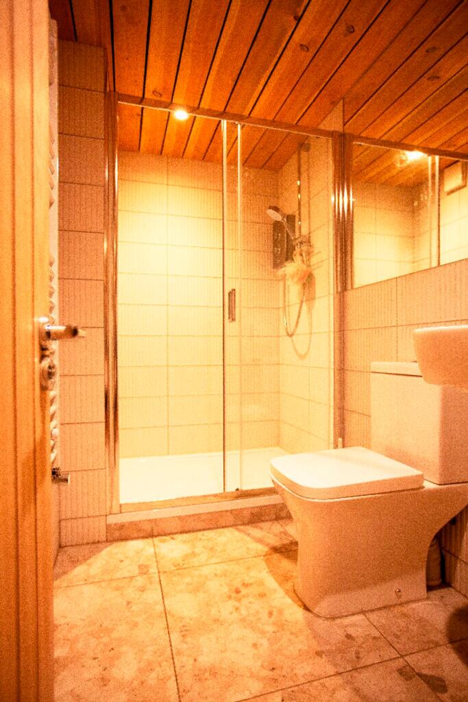 A modern bathroom featuring a glass shower and ...