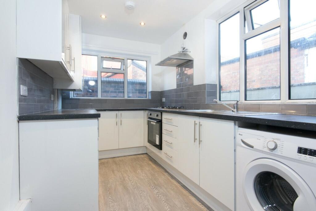 A bright and modern kitchen equipped with essen...