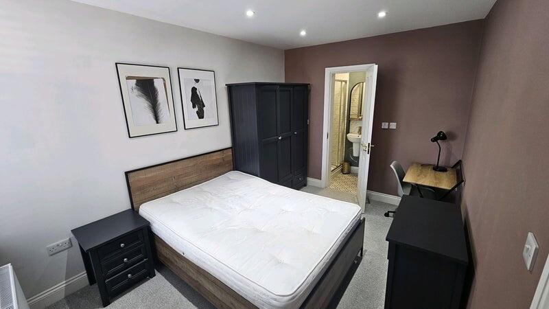 A modern master bedroom featuring a comfortable...