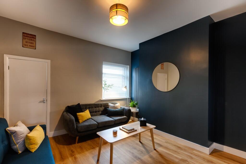 A stylish and well-lit living room featuring a ...