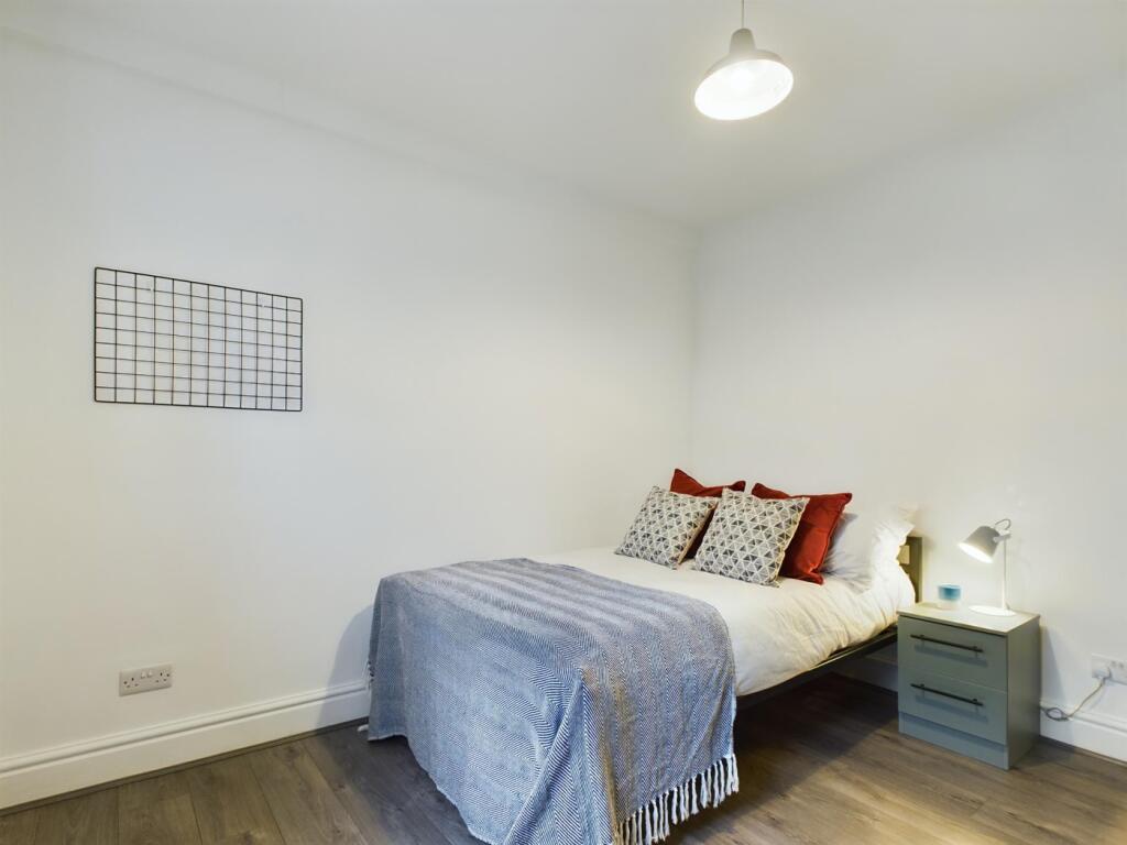 A bright and inviting double bedroom featuring ...