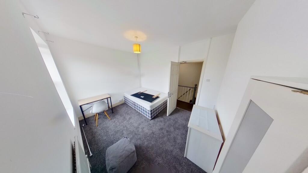 Bright and tidy bedroom featuring a large windo...