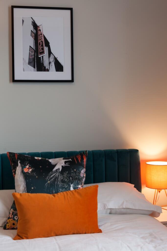 A stylish master bedroom featuring a plush bed ...