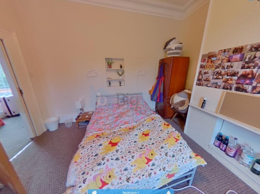 Cozy single bedroom featuring a neatly made bed...