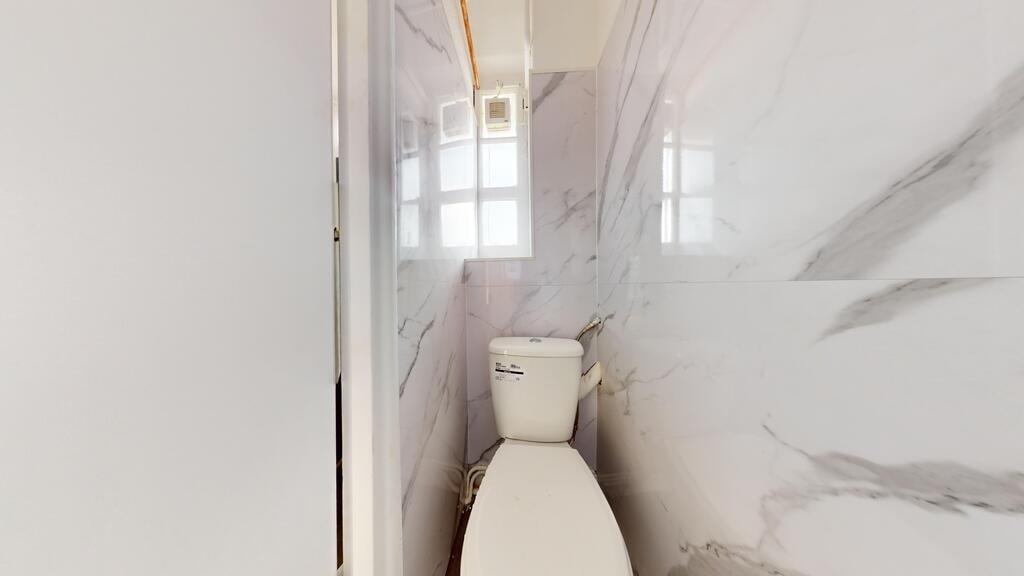 A clean and modern single toilet space featurin...