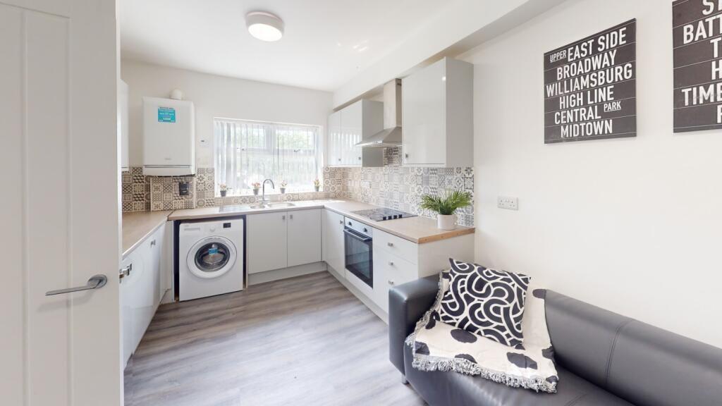 Bright and modern kitchen featuring sleek cabin...
