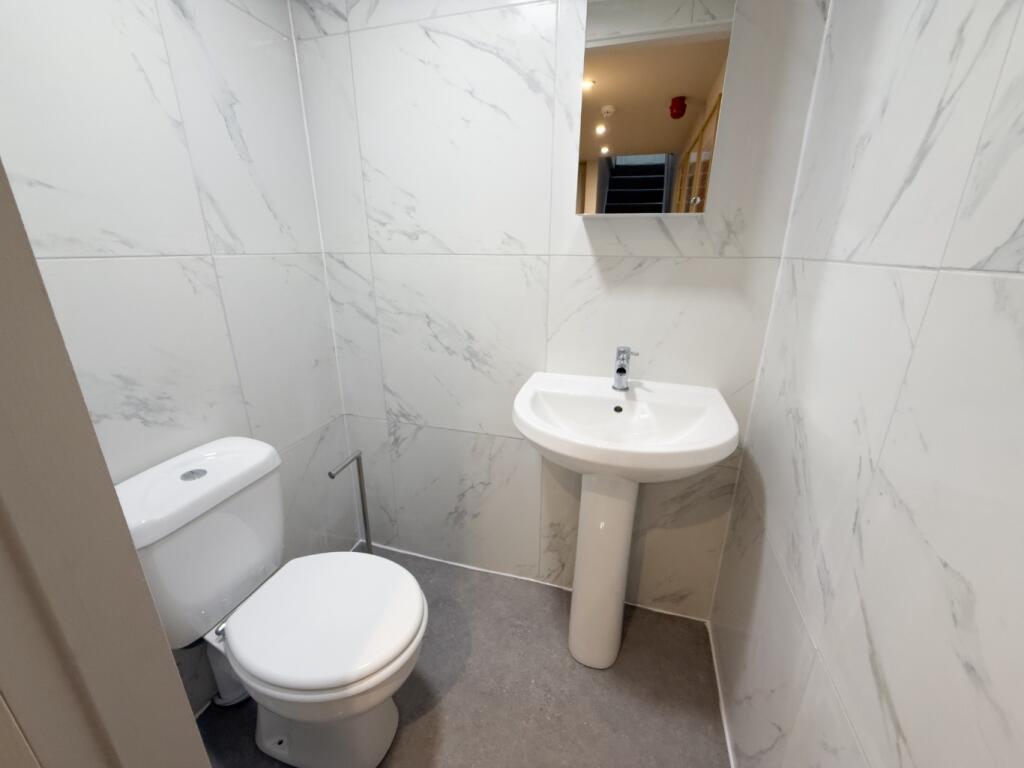 Bright, modern WC with white sanitaryware and c...