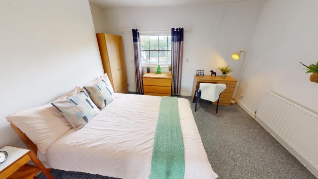 A bright and inviting double bedroom with moder...