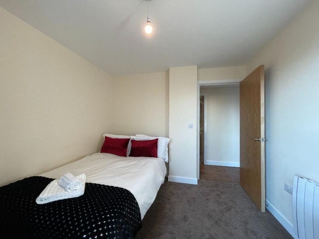 A cozy double bedroom featuring a comfortable b...
