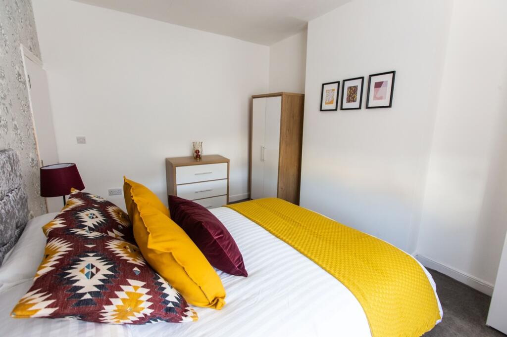 A clean and inviting double bedroom with bright...
