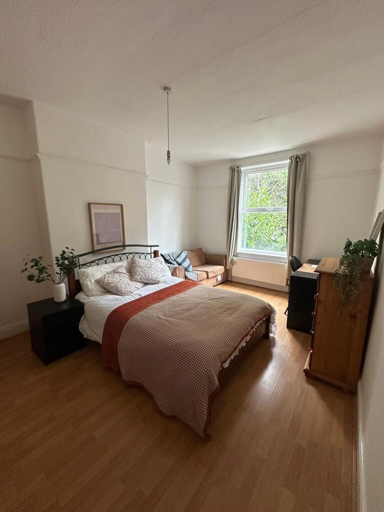 A spacious and well-lit bedroom featuring a com...