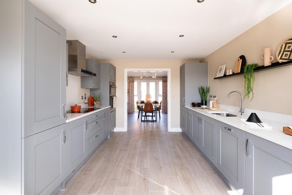 The kitchen leads through double doors to the separate dining room
