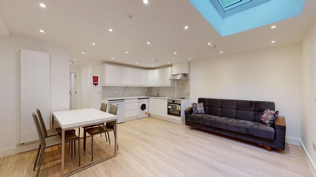 A modern, open-plan living room with a sleek wh...