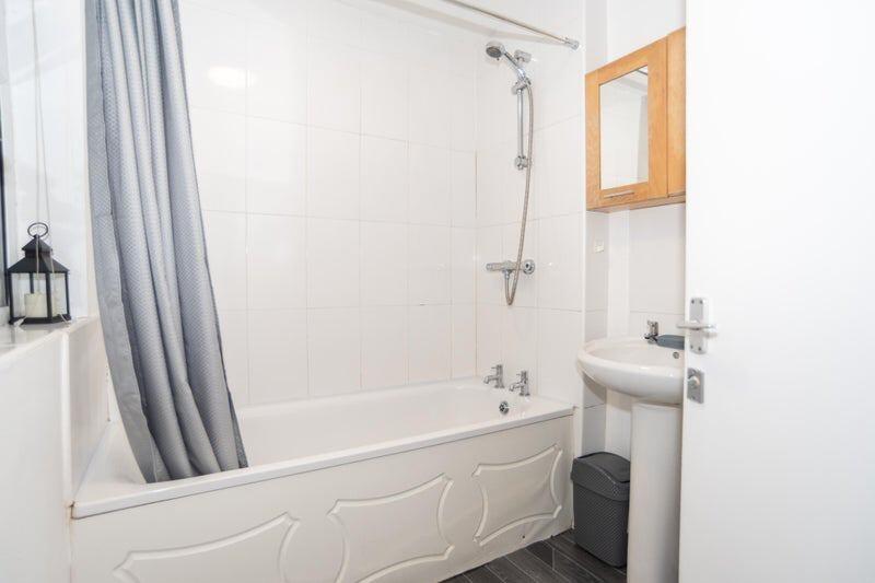 Bright, well-kept bathroom with a full bath and...