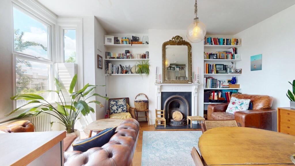 A bright and inviting living room featuring lar...