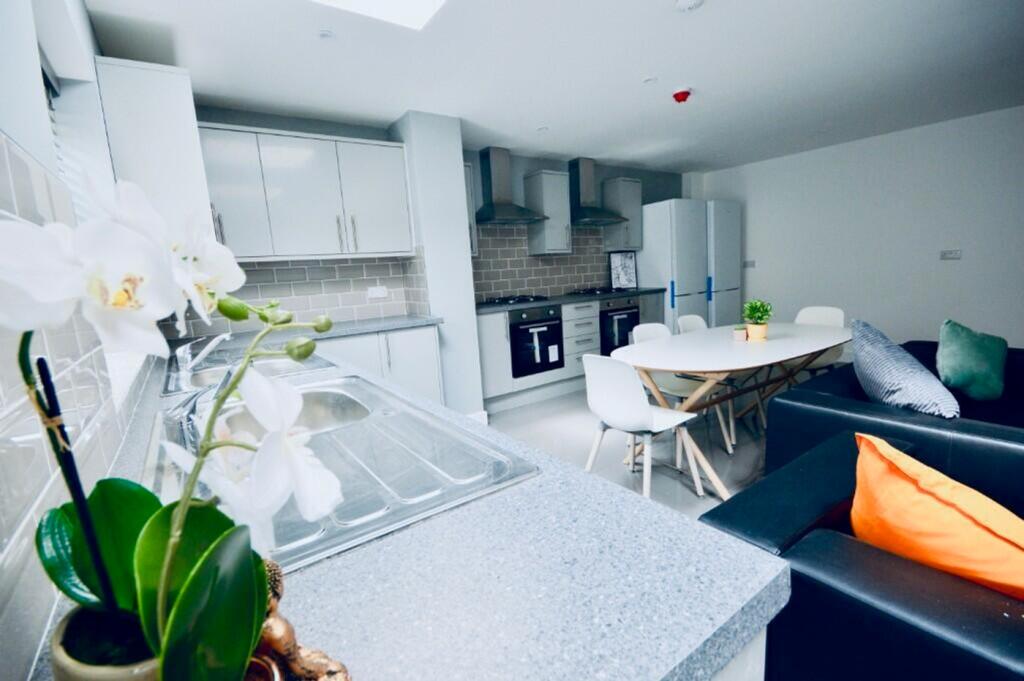 A modern and stylish kitchen area with ample sp...