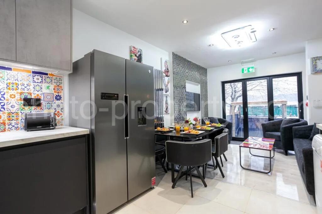 A modern kitchen featuring sleek appliances, a ...