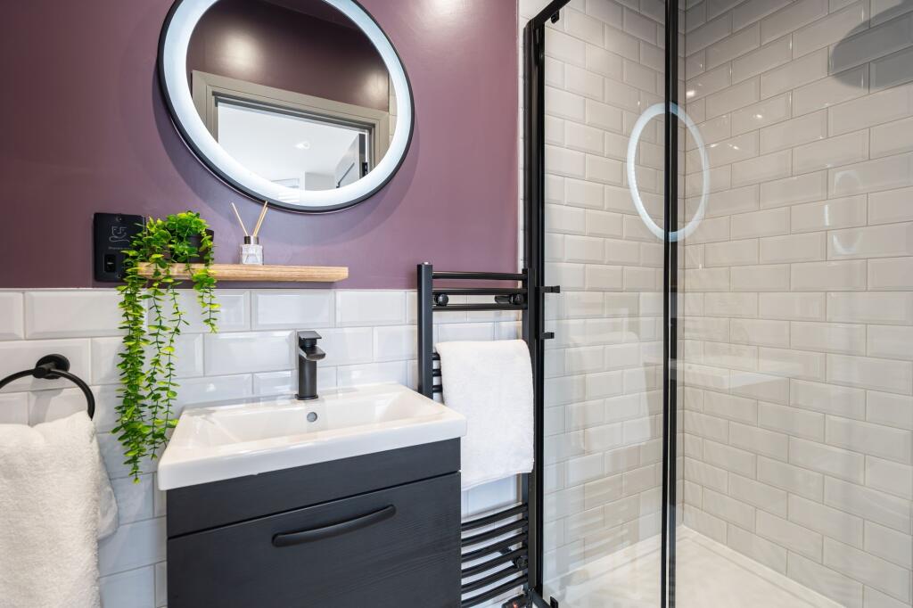 Modern, clean bathroom featuring a stylish sink...