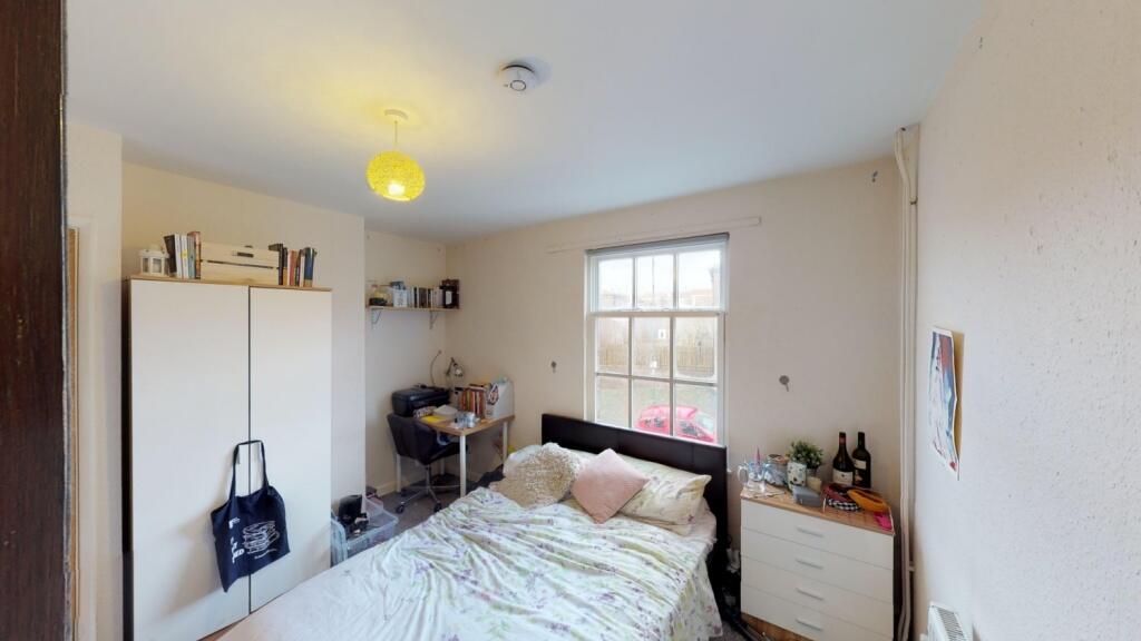 Bright and cozy double bedroom featuring a larg...