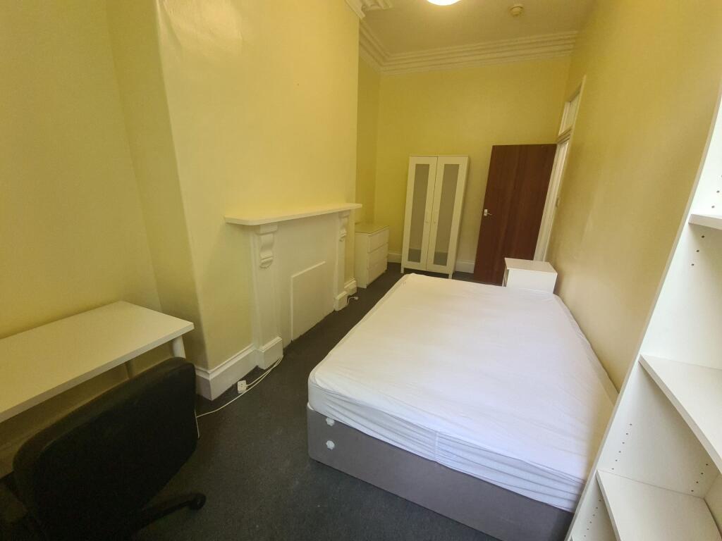 A well-maintained bedroom featuring a comfortab...