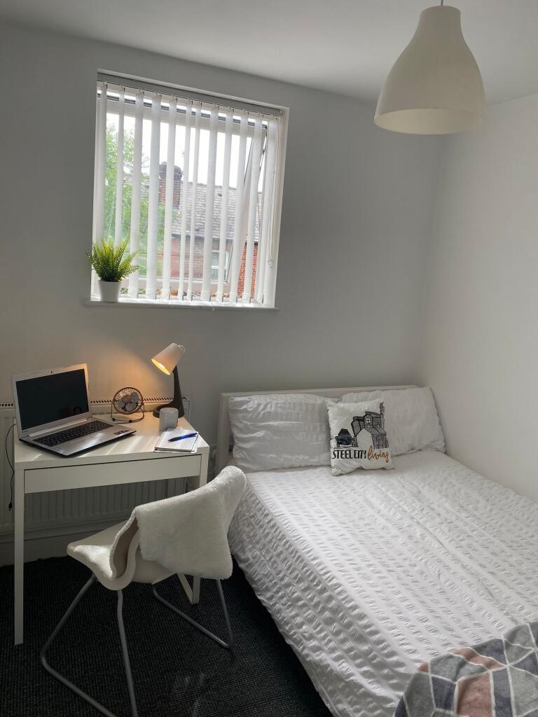 This charming double bedroom features a cozy am...