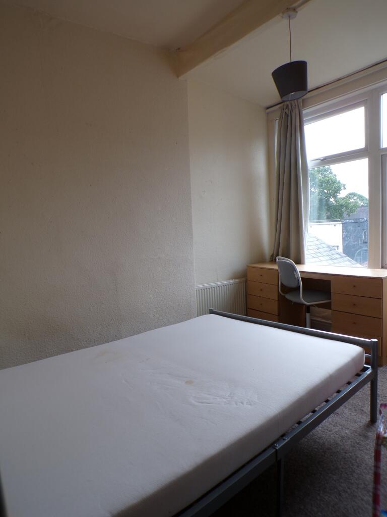 A bright and inviting double bedroom featuring ...