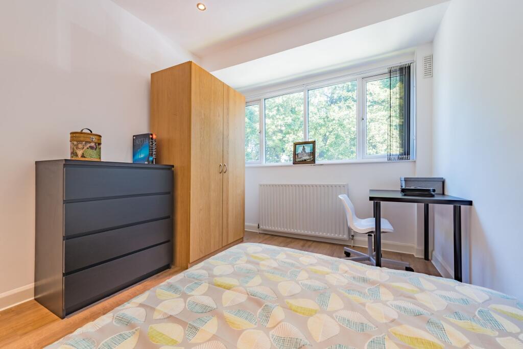 A clean and bright single bedroom featuring a l...