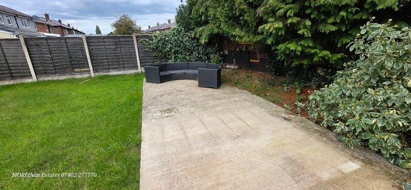 A well-maintained garden area featuring a spaci...