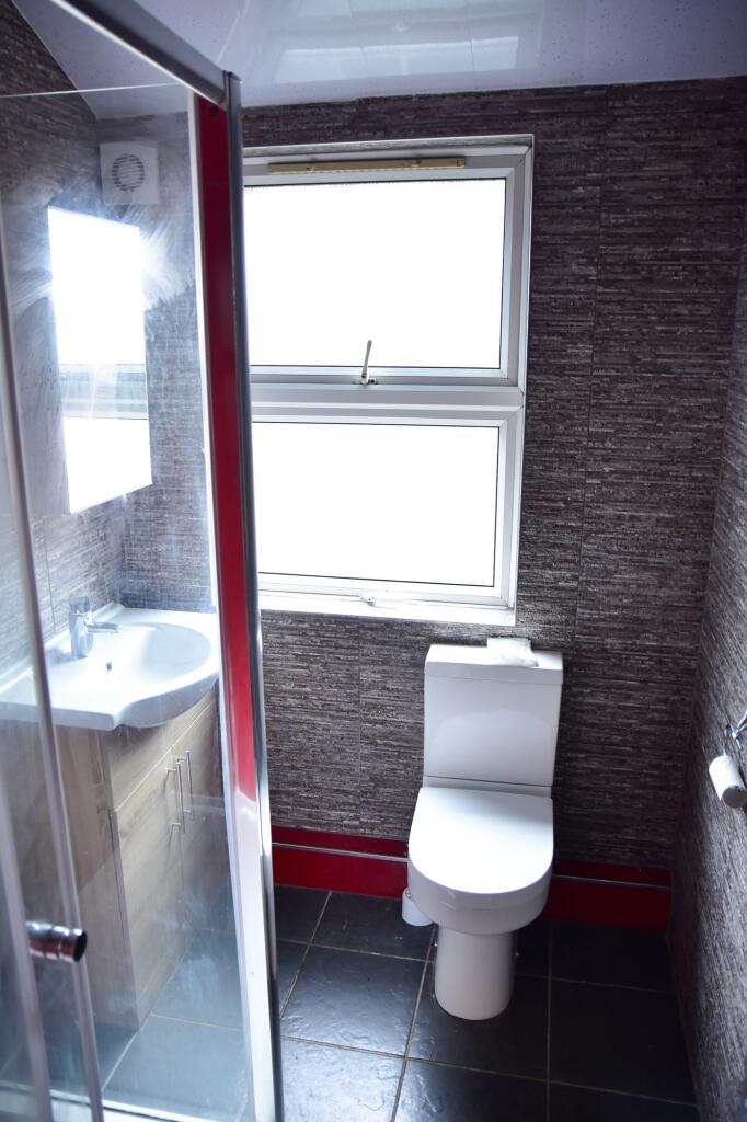 Modern bathroom with a compact design featuring...