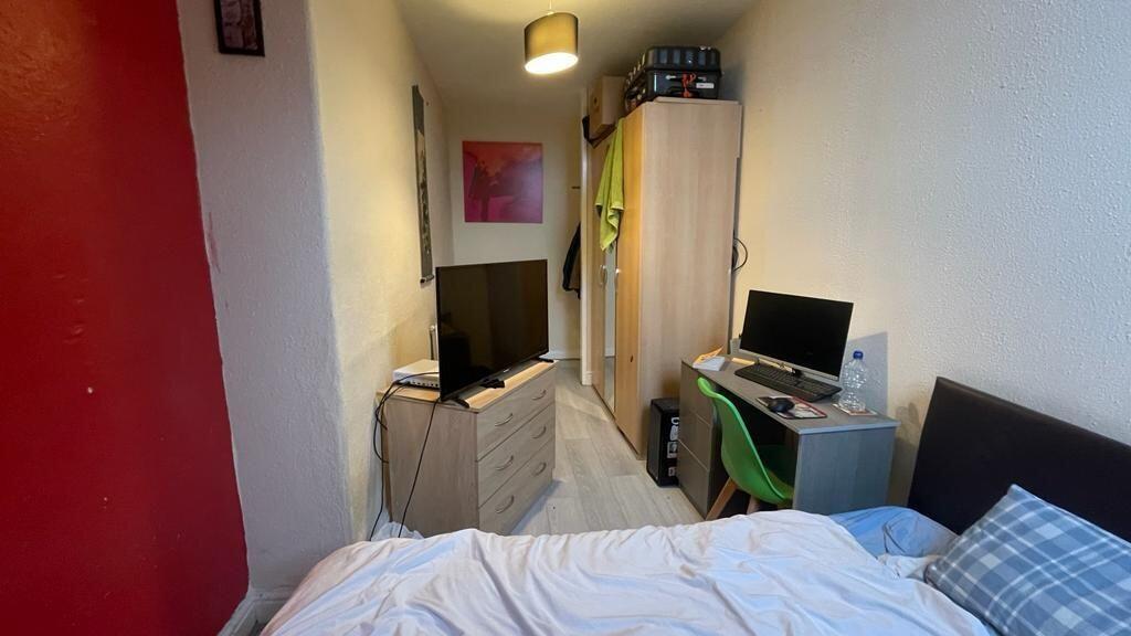 Cozy single bedroom featuring a comfortable bed...