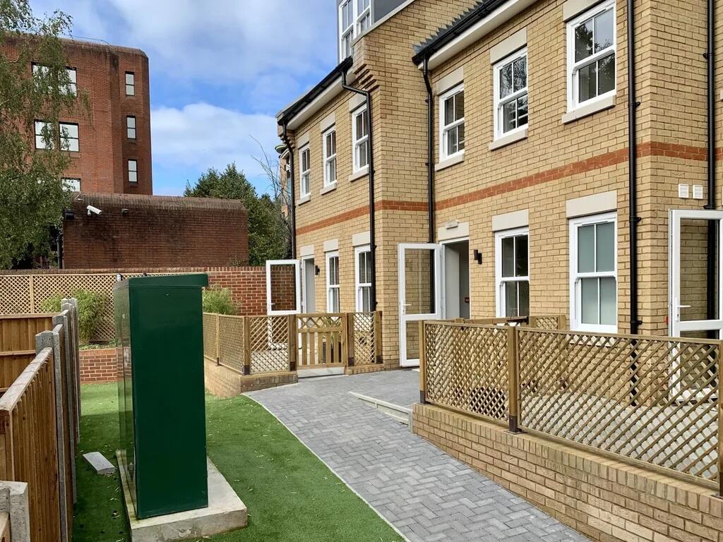 Modern terraced property featuring a neat paved...