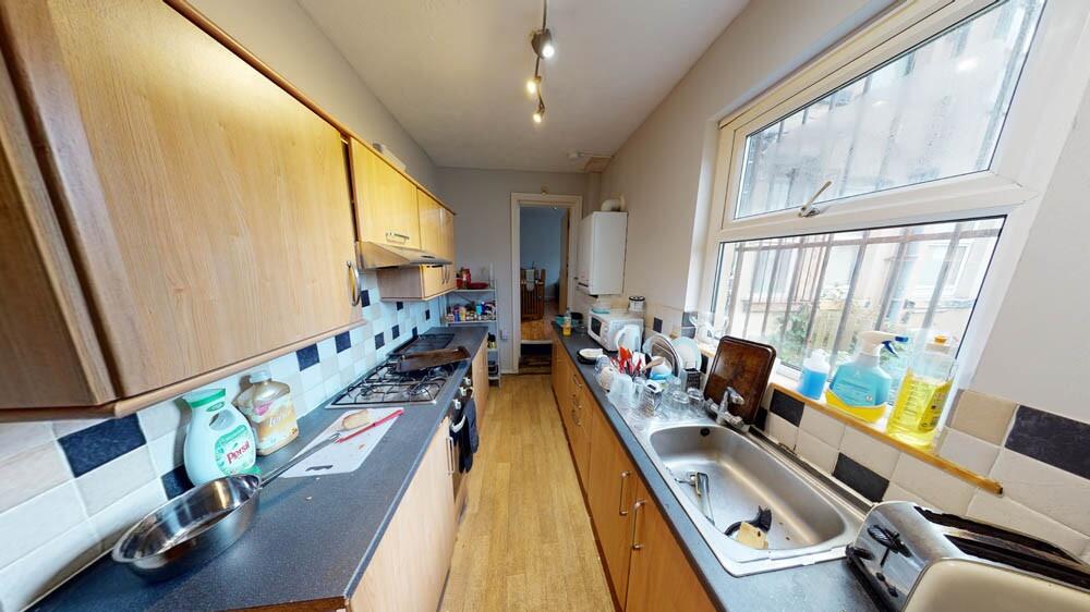 Bright galley kitchen with large windows, long ...