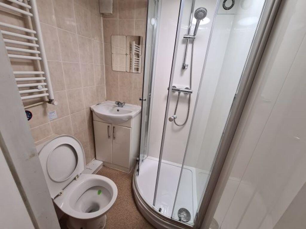 A clean and modern bathroom featuring a curved ...