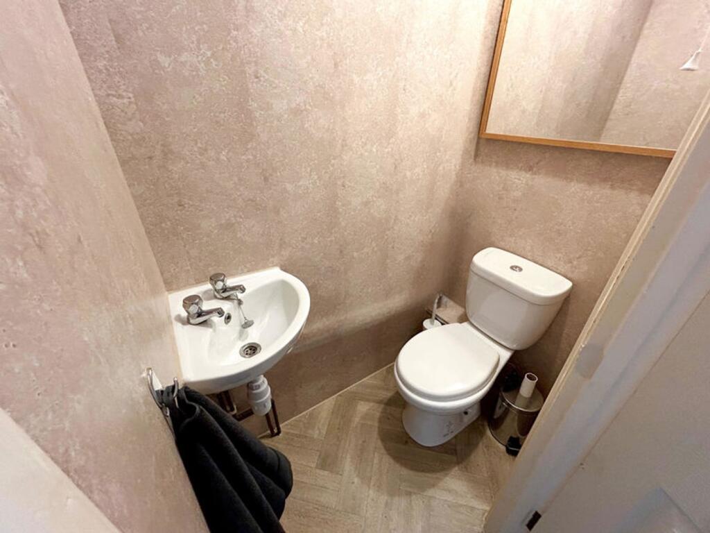 A tidy and functional single toilet with modern...