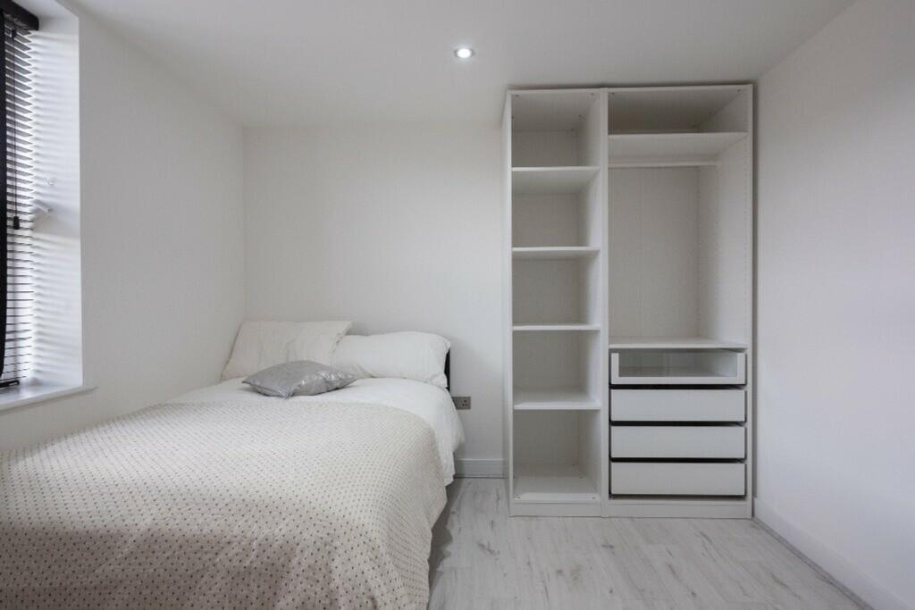 This modern double bedroom features a cozy layo...