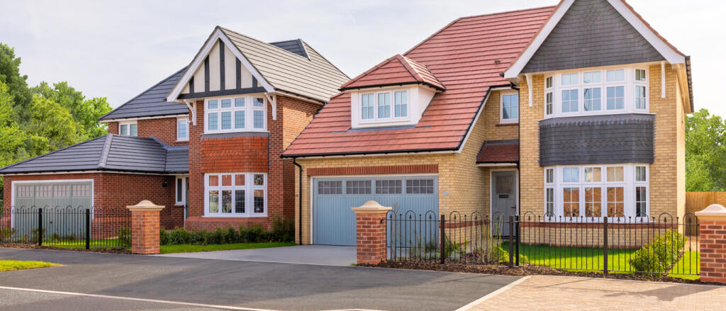 Modern detached homes with brick and tile exteriors, bay windows, and neatly maintained gardens at H