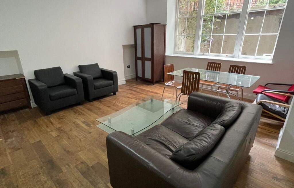 A cozy living room featuring a comfortable leat...