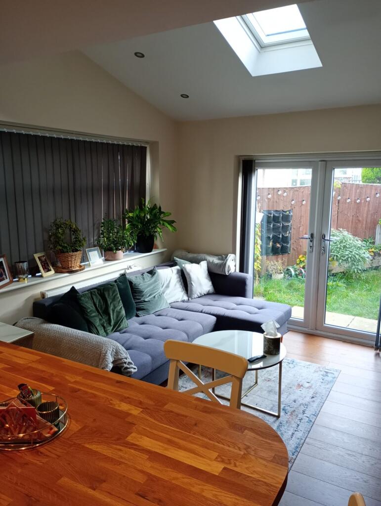 A modern and cosy living room featuring a comfo...