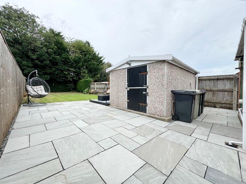 Patio area to outbuilding and garden