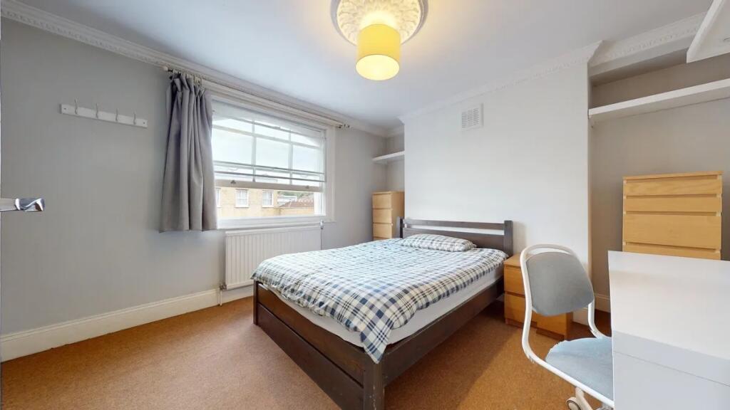 A bright and inviting double bedroom featuring ...