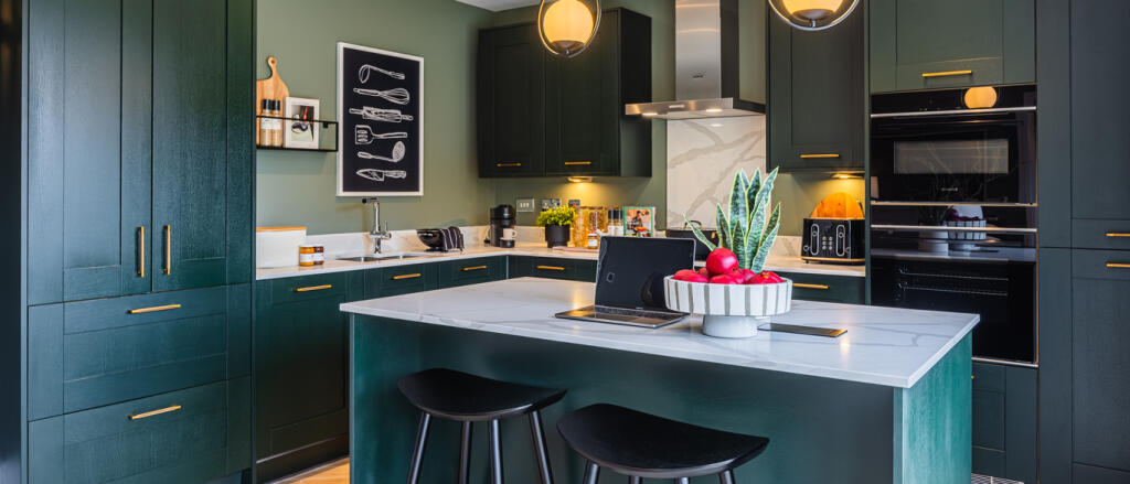 Redrow dark green kitchen design with island complete with bar stools