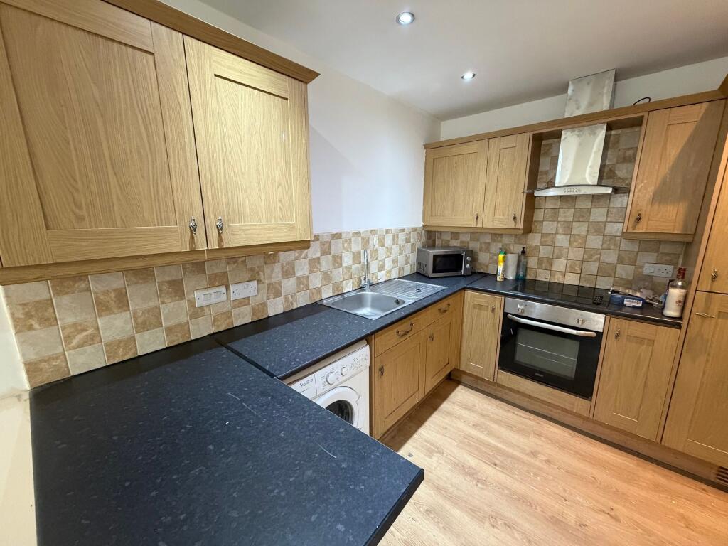 A well-maintained kitchen featuring wooden cabi...