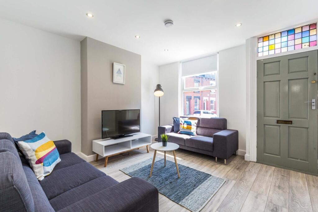A bright and welcoming living room featuring co...