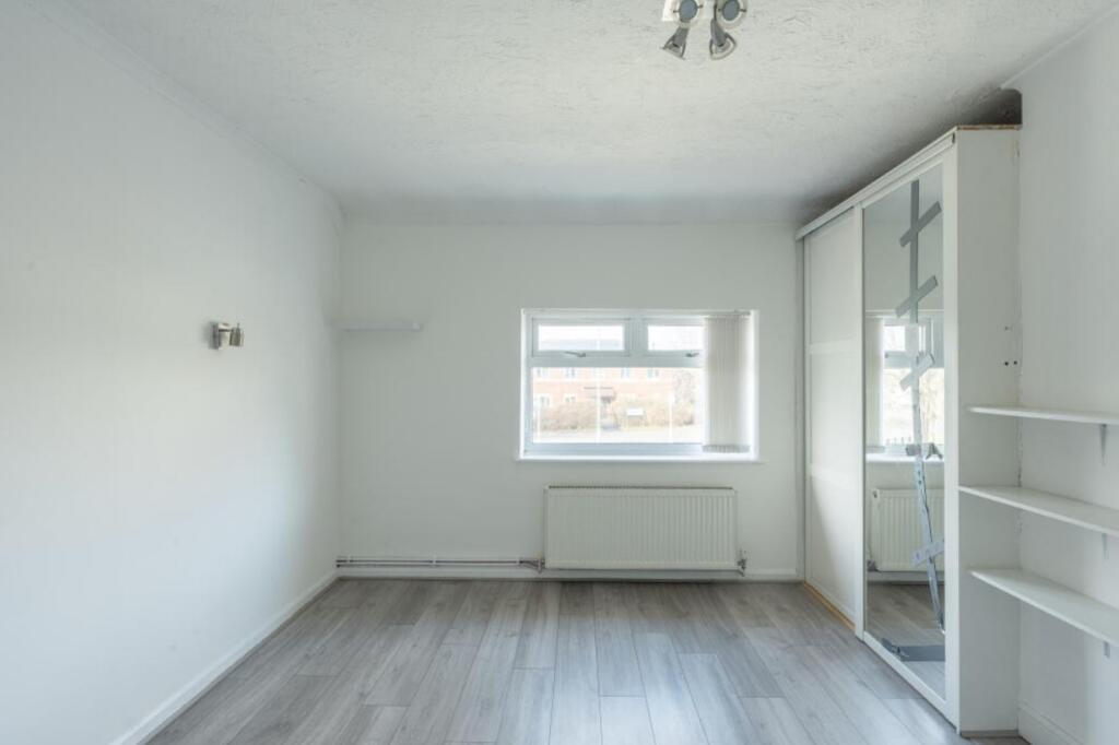 A bright and tidy double bedroom with ample sto...