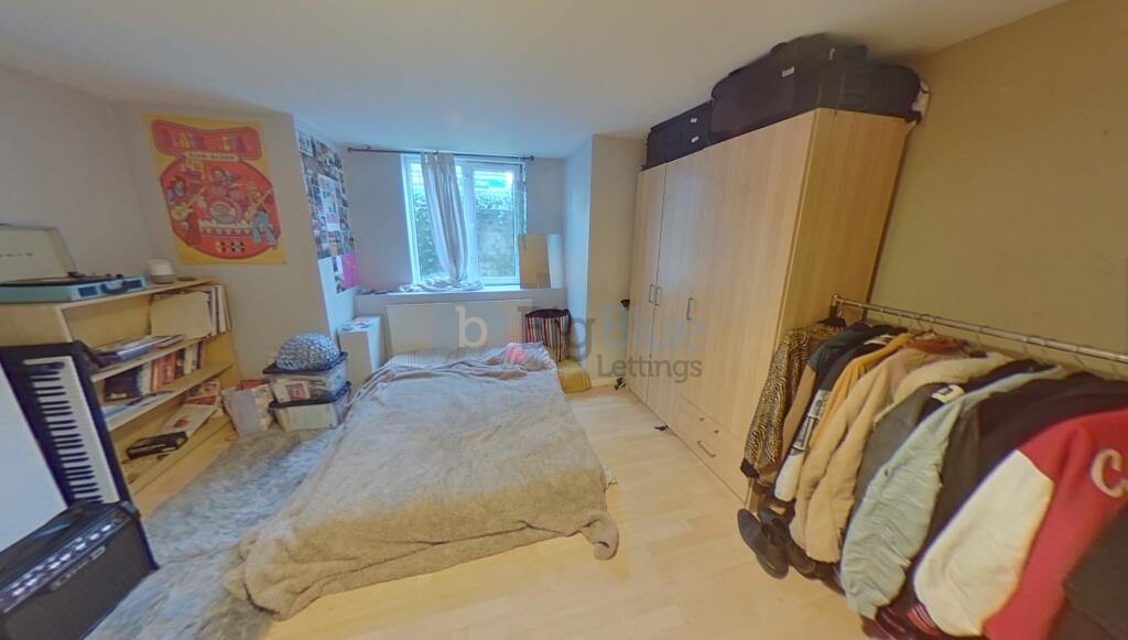 A spacious and inviting bedroom featuring a lar...