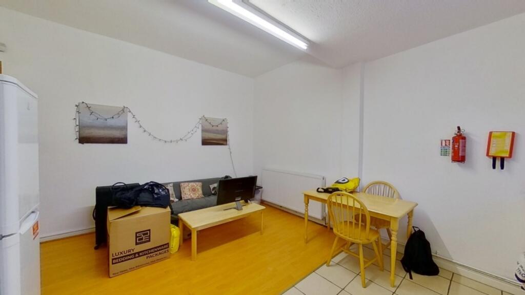 A cozy living room space with bright lighting, ...