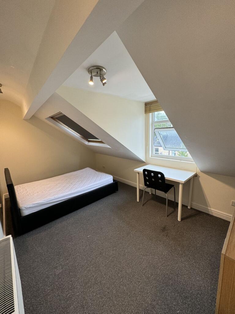 A well-maintained bedroom featuring a single be...